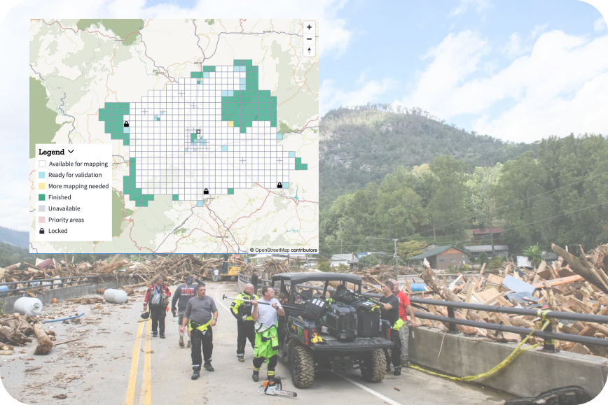 Emergency personnel are observed on a road as the Rocky Broad River merges into Lake Lure, carrying debris from Chimney Rock, North Carolina